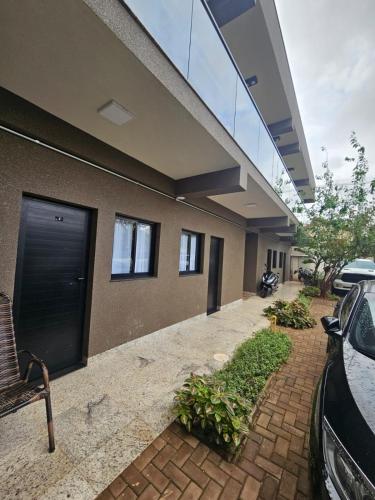 a building with a car parked in front of it at Estância Ana S Diniz in Barretos