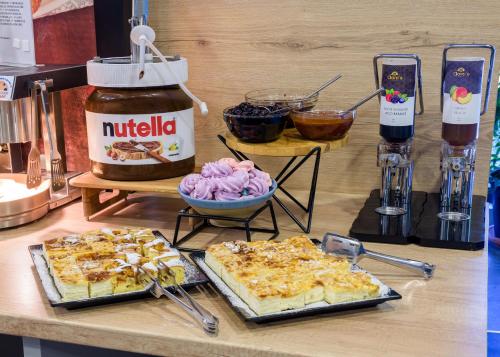 a counter with some food on a table at HOTEL CARPAT INN in Azuga