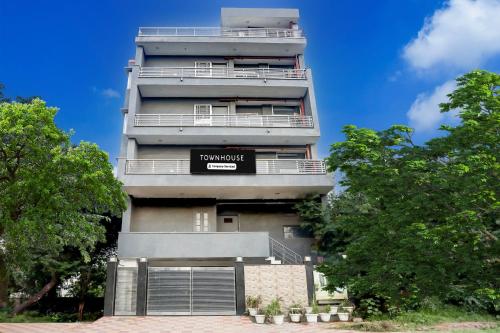 a tall building with a sign on it at Super Townhouse Rohini Sector 24 in New Delhi