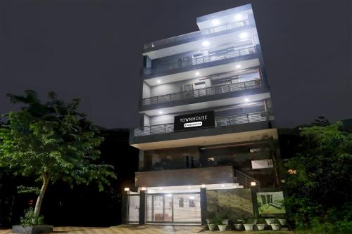 a tall building with lights on it at night at Super Townhouse Rohini Sector 24 in New Delhi