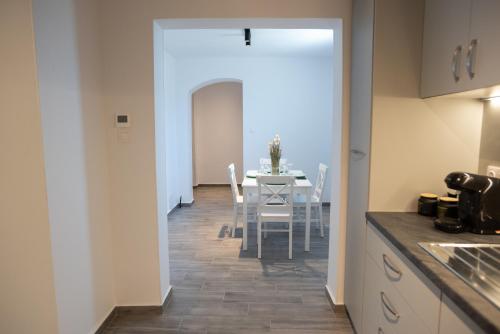 a kitchen and dining room with a table and chairs at Celine House in Volos
