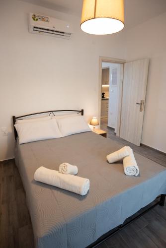 a bedroom with a large bed with towels on it at Celine House in Volos
