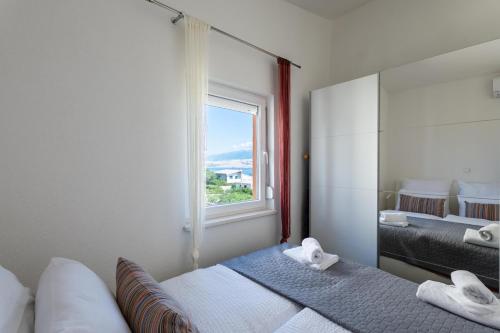 a bedroom with two beds and a window at Bayview Villa by Pag tours in Pag