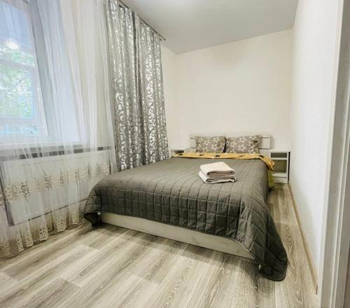 Un dormitorio con una cama y una ventana en new apartment near the center квартира в новому будинку поруч з центром, en Sumy