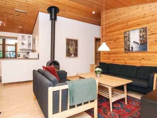 a living room with a couch and a table at 4 star holiday home in Ebeltoft in Ebeltoft