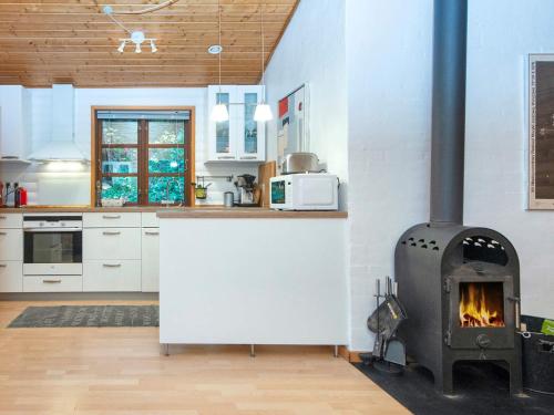 a kitchen with a stove in the middle of a room at 4 star holiday home in Ebeltoft in Ebeltoft