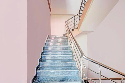 a staircase in a building with blue stairs at Super Hotel O Ramarvapadu Near ESI Hospital in Vijayawada