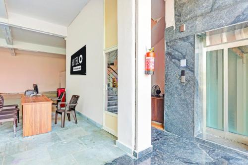 a lobby with a table and chairs in a building at Super Hotel O Ramarvapadu Near ESI Hospital in Vijayawada