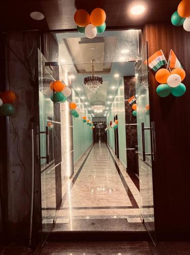 a hallway in a building with orange and green decorations at Hotel Nalanda City in Nalanda