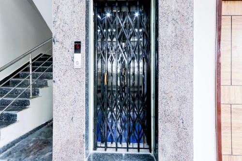 a door with a black iron gate on a building at Super Hotel O Adibatla near TCS in Hyderabad