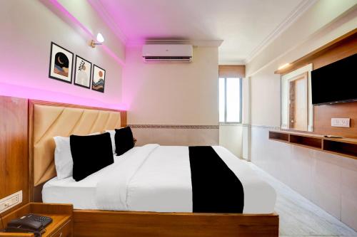 a bedroom with a bed and a tv at Super Collection O Ahmedabad Airport Formerly Hotel Runway Inn in Ahmedabad