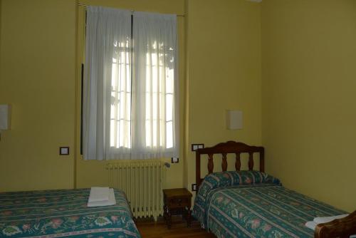 a bedroom with two beds and a window at Dehesa de San Juan in Milagro