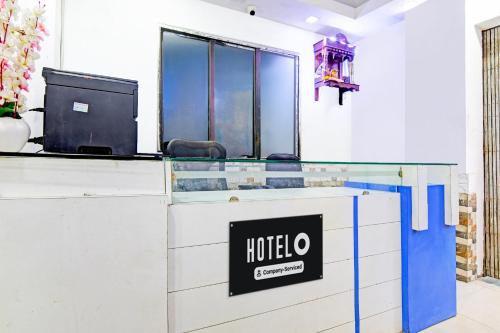 a hotel reception desk with a hotel sign on it at Super Hotel O Santragachi Junction Formerly Hotel Shubra in Kolkata