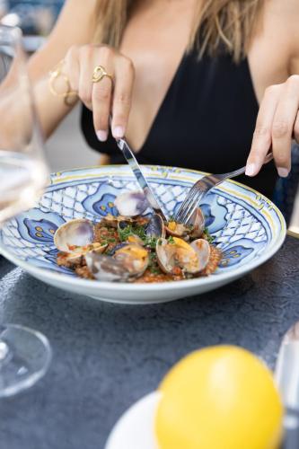 a woman sitting at a table eating a plate of food at La Villa in Montreux
