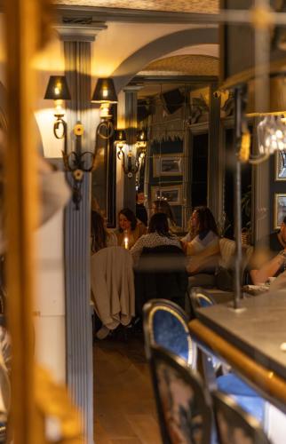 a group of people sitting at a table in a restaurant at La Villa in Montreux