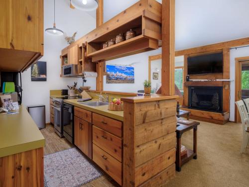 a kitchen with a sink and a stove top oven at RMR: Hawthorne 222 Condo in The AspensWilsonWY in Wilson