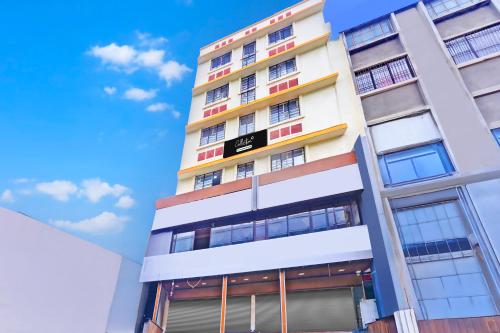 a tall apartment building with colorful windows at Super Collection O Katraj Near KK Market in Pune