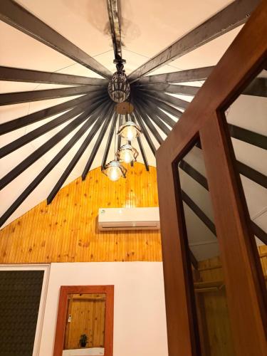 a chandelier hanging from a ceiling in a room at Tribal Village in Trincomalee