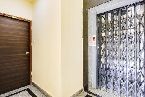 a door to a building with a metal gate at Super Hotel O Guntur in Guntūr