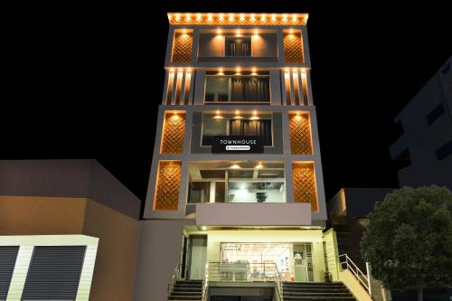 a tall building with lights on it at night at Super Townhouse Badangpet Crossway Hyderabad Formerly Balapur in Surūrnagar