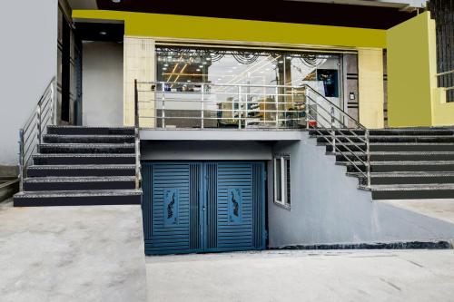 a building with a blue door and stairs at Super Townhouse Badangpet Crossway Hyderabad Formerly Balapur in Surūrnagar