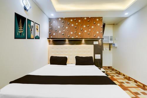 a bedroom with a white bed in a room at Super Collection O Jagdeo Path Patna in Patna