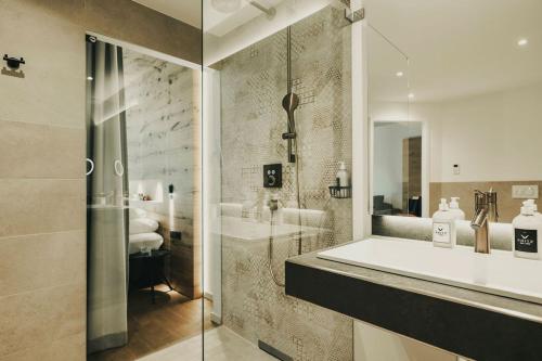 a bathroom with a tub and a sink and a shower at Fritz Lauterbad in Freudenstadt