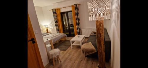 a bedroom with a bed and a table and a lamp at Jeleni Ruczaj in Karpacz