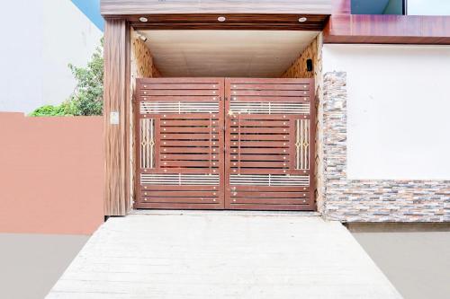 a wooden door on the side of a building at Super Hotel O BLW Kakarmatta Near Banaras Junction in Varanasi