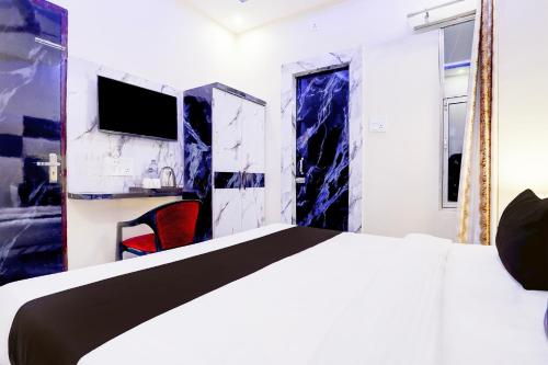 a hotel room with a bed and a tv at Super Collection O Subedarganj Railway Station Prayagraj in Prayagraj