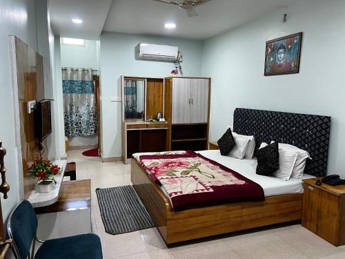 a bedroom with a large bed in a room at Hotel Priyanka in Raisen