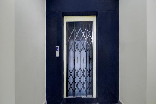 a black door with a metal gate on a building at Super Collection O Kothapet Near Omini Hospital in Upal