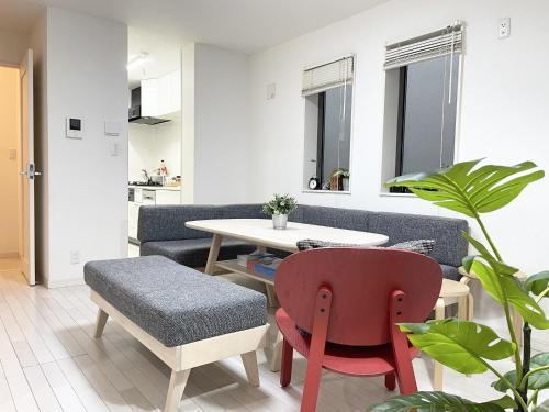 a living room with a couch and a table and chairs at Hotel chen's house - Vacation STAY 42508v in Tokyo