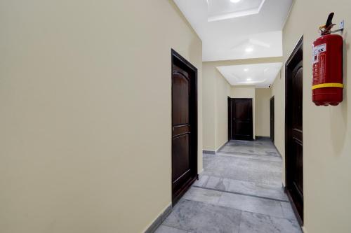a hallway with a fire extinguisher on the wall at Super Collection O Kothapet Near Omini Hospital in Upal