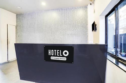 a hotel sign on a wall in a room at Super Hotel O Hingna Road Wanadongri in Nagpur