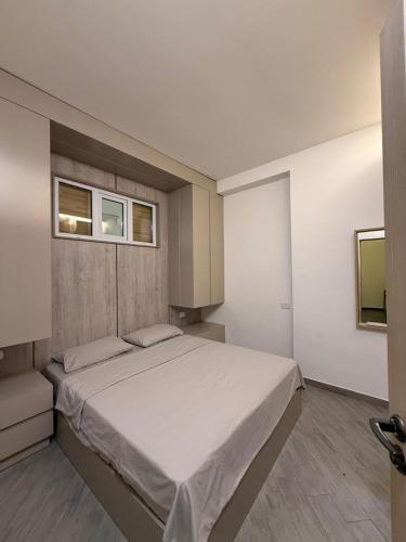 a bedroom with a large bed and two windows at Stylish 2BR Apartment with Balcony by Republic Square - City Center I Стильные апартаменты с 2 спальнями и балконом у площади Республики-Центр Города in Yerevan