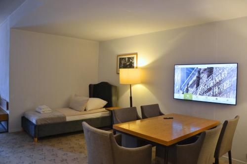 a hotel room with a bed and a table at Great Polonia The Granary La Suite Hotel in Wrocław