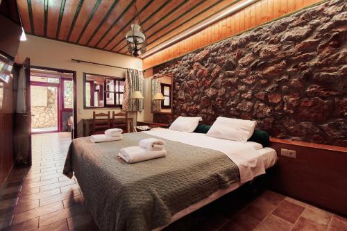 a bedroom with a large bed with towels on it at NafplioBiofarms Country Apartments in Nafplio