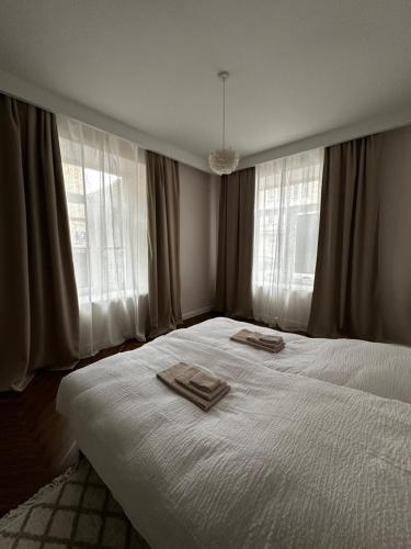 a bedroom with a bed with two towels on it at Downtown apartment at Kelles Krauza in Radom
