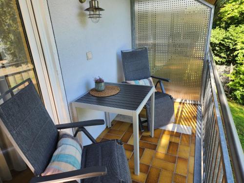 a porch with chairs and a table on a balcony at Winzerhof Düring in Iphofen