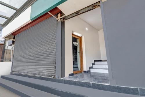 a metal garage door on the side of a building at Super Hotel O Anayara Near Lulu Mall formerly Timber Residency in Trivandrum