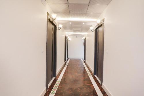 a corridor in an office building with a long hallway at Super Collection O Quila Road Formerly JR Inn in Lucknow