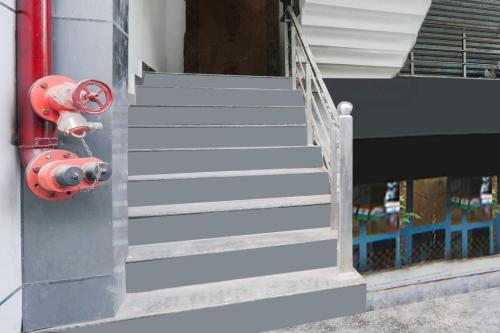 a set of stairs next to a fire hydrant at Super Collection O Quila Road Formerly JR Inn in Lucknow