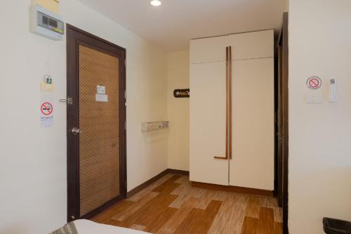 a room with a closet and a door in it at My Way Hua Hin Music Hotel SHA Extra Plus in Hua Hin