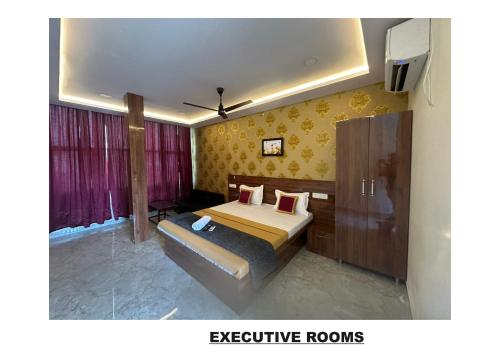 a bedroom with a bed and a tv in it at Athithi Comforts in Mysore
