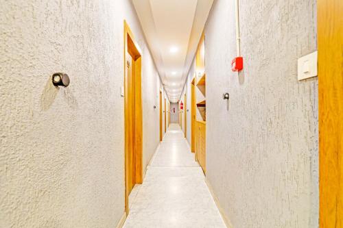 a corridor of an alley with white walls and a long aisle at Super Collection O Adajan Formerly Hotel Western Inn in Surat