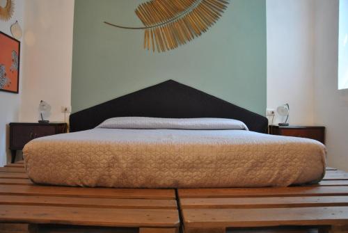 a bed sitting on a wooden platform in a bedroom at B&B 18 Gradini in Cuggiono
