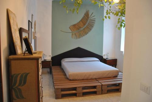 a bedroom with a bed and a wall with a painting at B&B 18 Gradini in Cuggiono