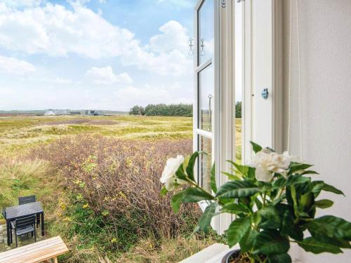 a window with a view of a field at 6 person holiday home in Harboøre-By Traum in Harboør