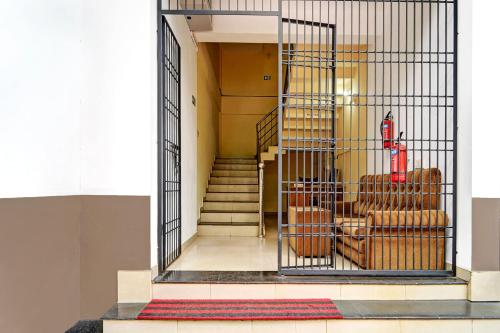 a cage with chairs and stairs in a building at Super Hotel O West Hill near Mietra Hospital in Calicut